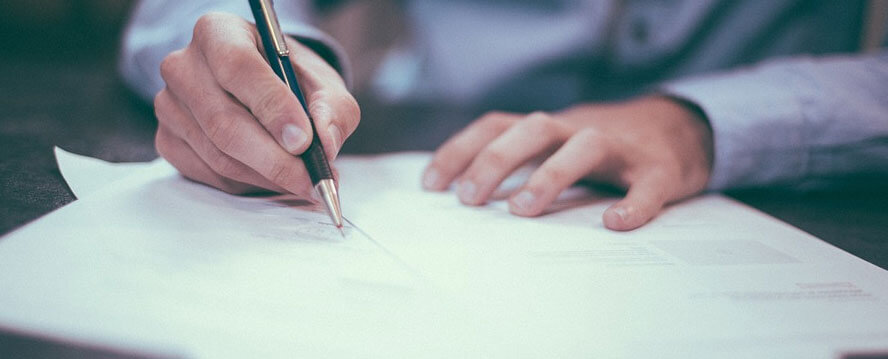 Man Writing on a Chart in Office